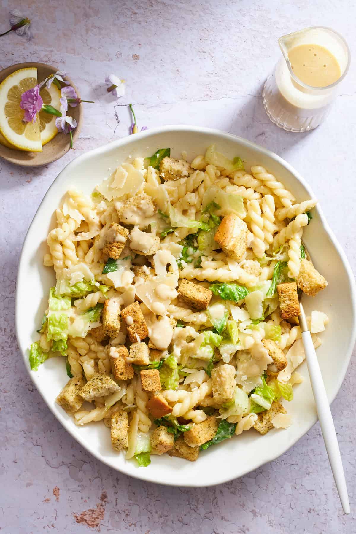 A bowl of Caesar pasta salad.