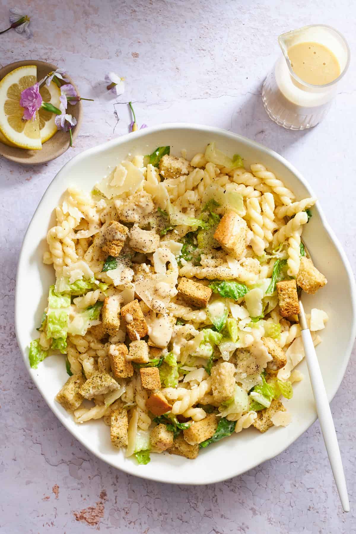 A bowl of Caesar pasta salad.