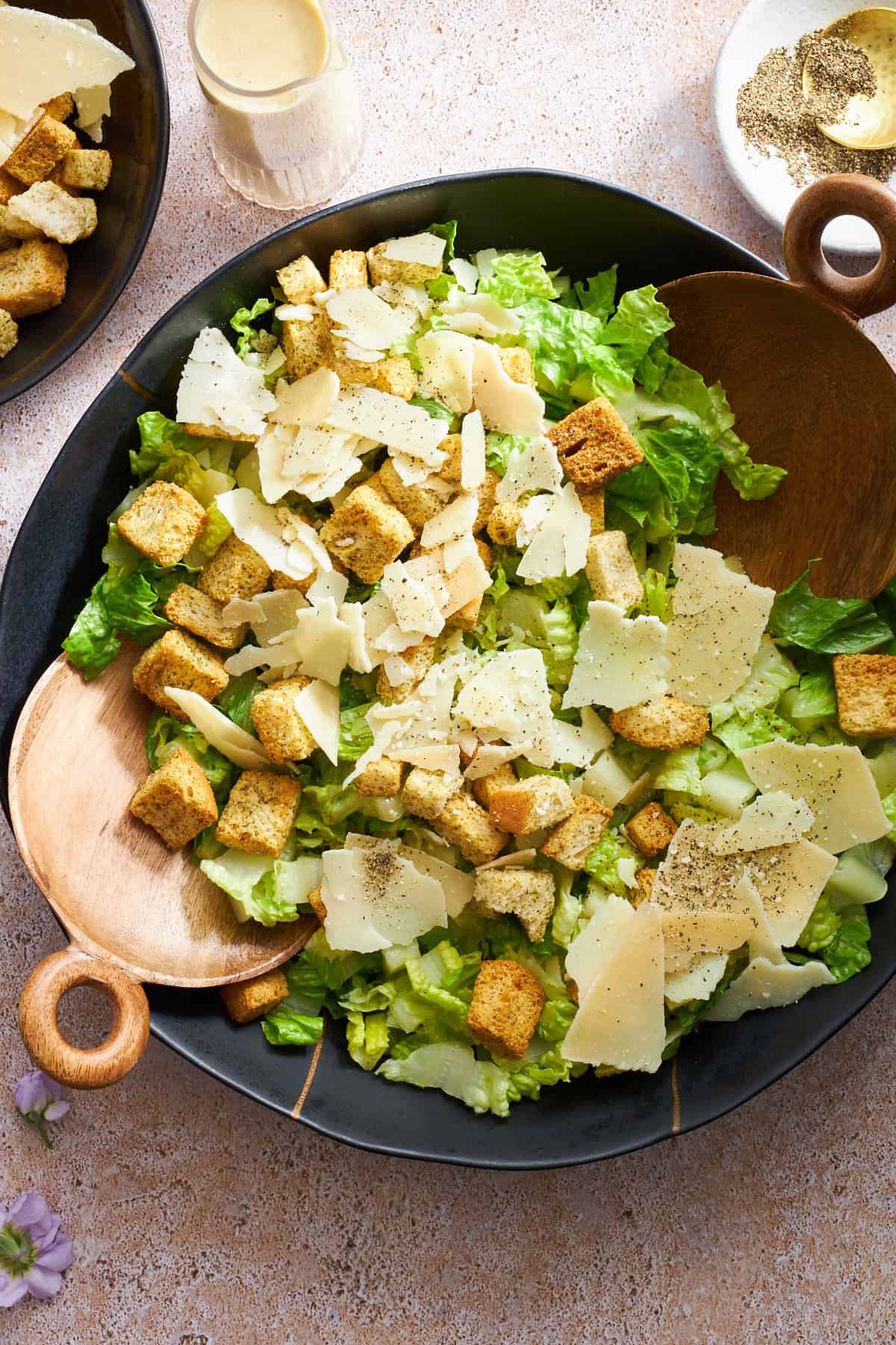 Overhead image of a bowl of Caesar salad without dressing. 