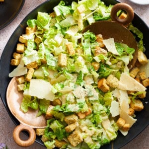 Overhead image of a bowl of Caesar dressing topped with dressing.