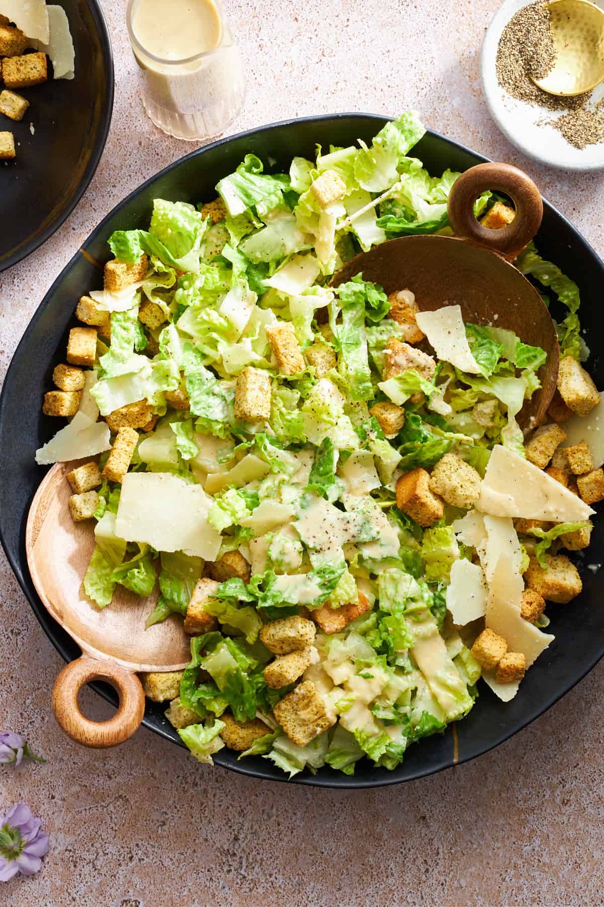 Overhead image of a bowl of Caesar dressing topped with dressing.