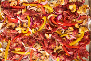 Philly cheesesteak filling on a baking sheet.