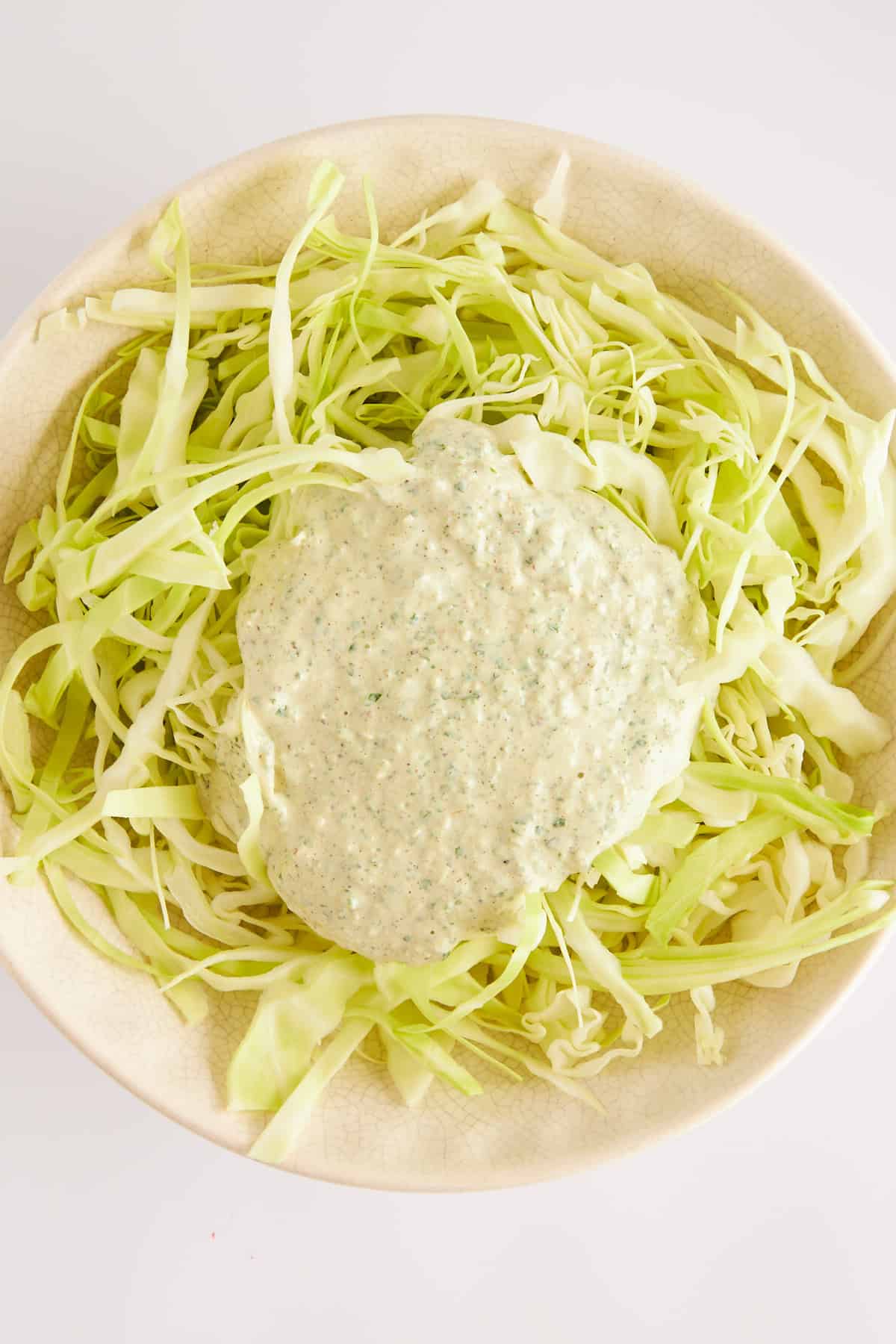 Shredded cabbage topped with dressing. 