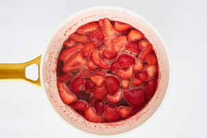 Strawberries cooking in a saucepan.