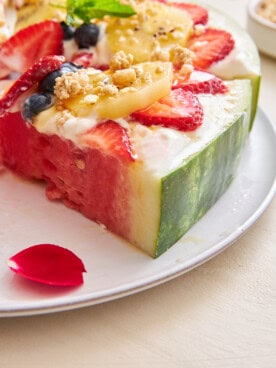 Watermelon pizza with a slice missing.