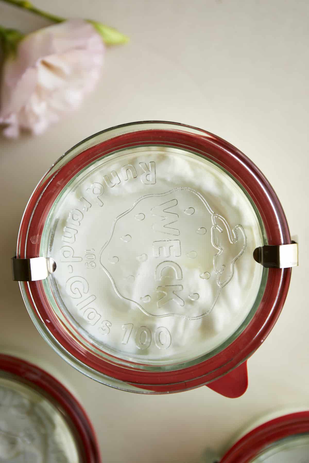 Overhead image of a Weck jar full of homemade Greek yogurt.