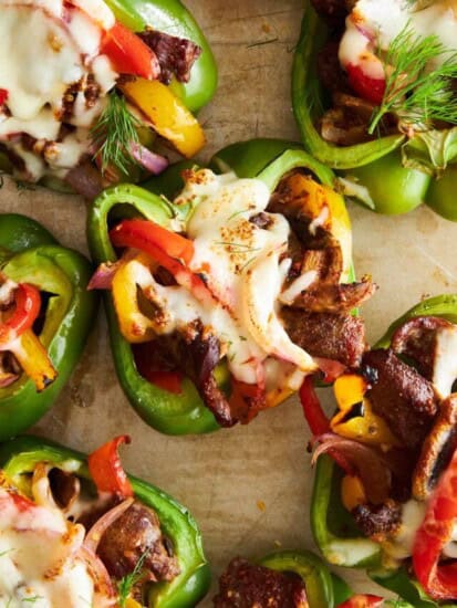 Philly cheesesteak stuffed peppers on a baking sheet.