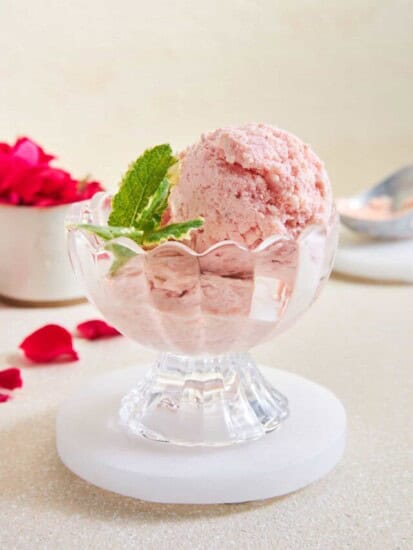 A serving cup of strawberry fruit ice cream.