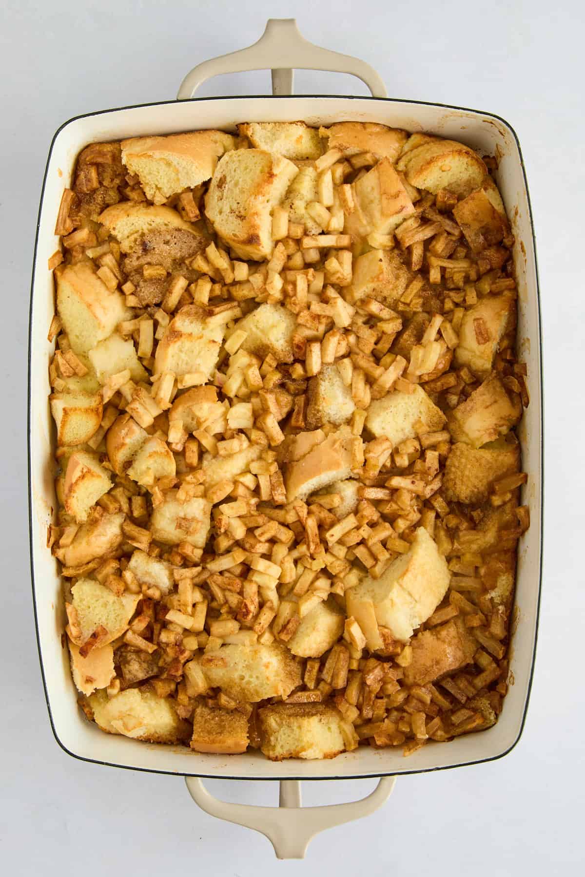 Overhead image of unbaked apple cinnamon french toast casserole. 