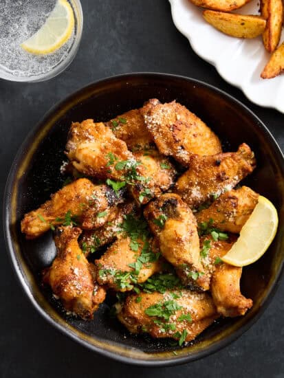 A bowl of parmesan garlic chicken wings.