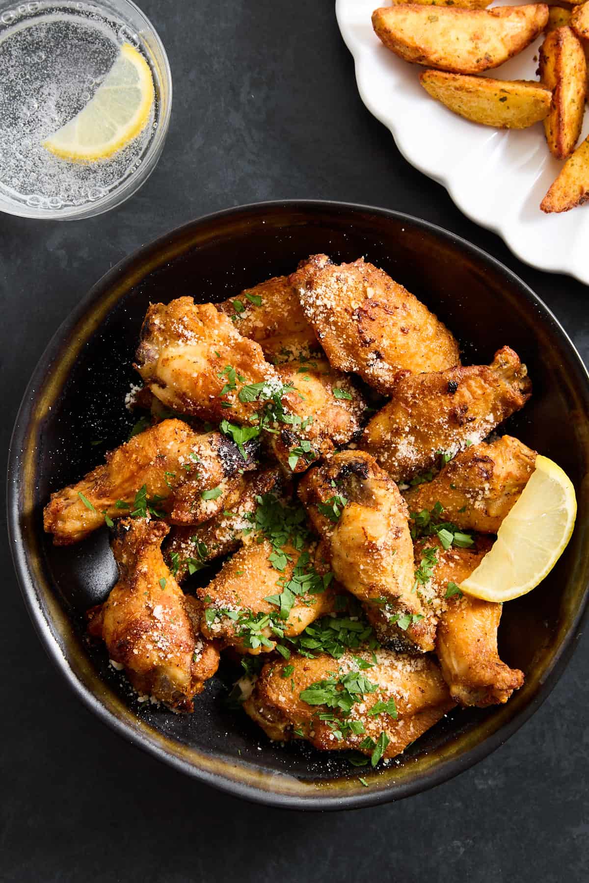 A bowl of parmesan garlic chicken wings. 