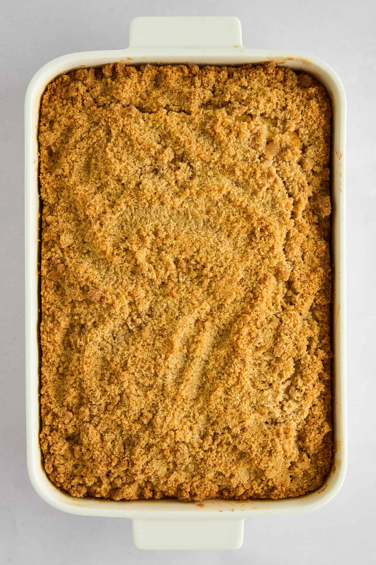 Overhead image of apple crumb cake in a baking dish. 