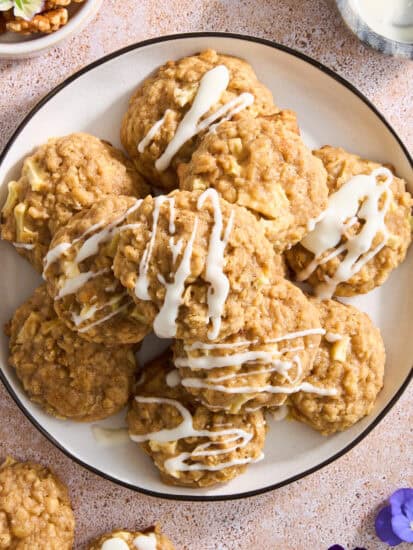 A plate of apple cookies with cream cheese frosting.