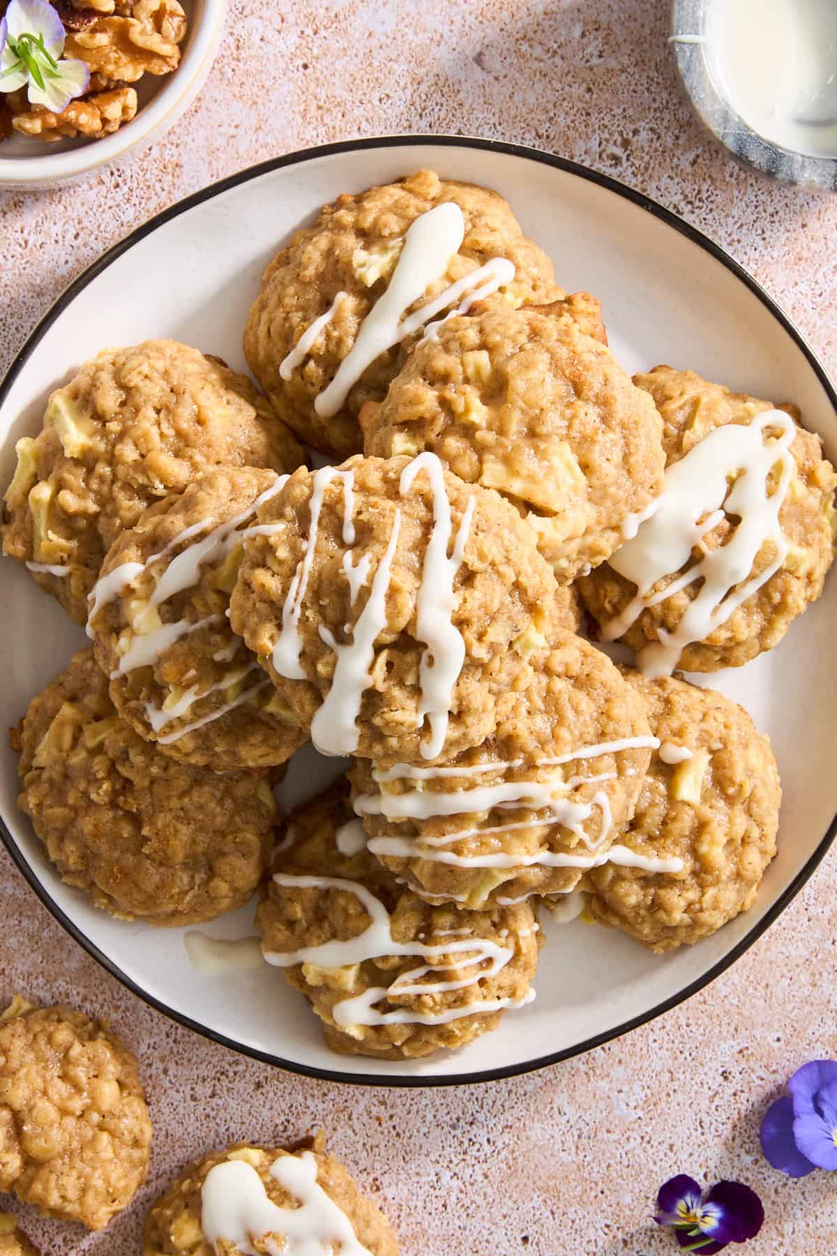 A plate of apple oatmeal cookies with cream cheese frosting. 