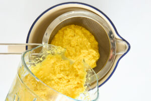 Turmeric shots being strained.