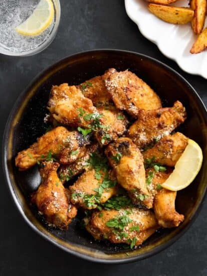 A bowl of parmesan garlic chicken wings.