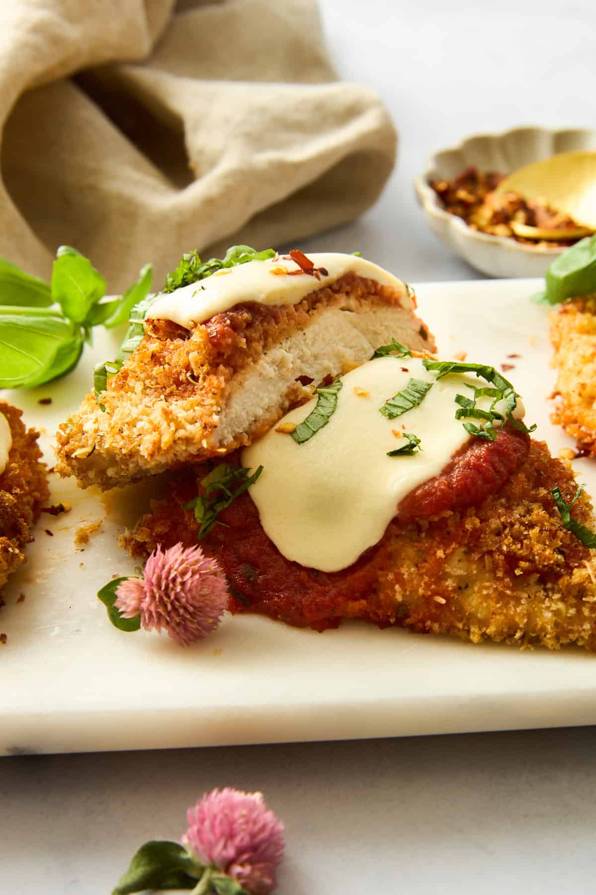 Baked Chicken Parmesan sliced on a plate. 