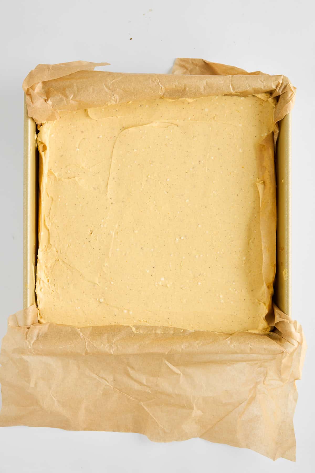 Overhead image of no-bake pumpkin cheesecake bars in a pan. 