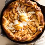 An apple galette topped with ice cream and caramel.