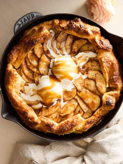 An apple galette topped with ice cream and caramel.