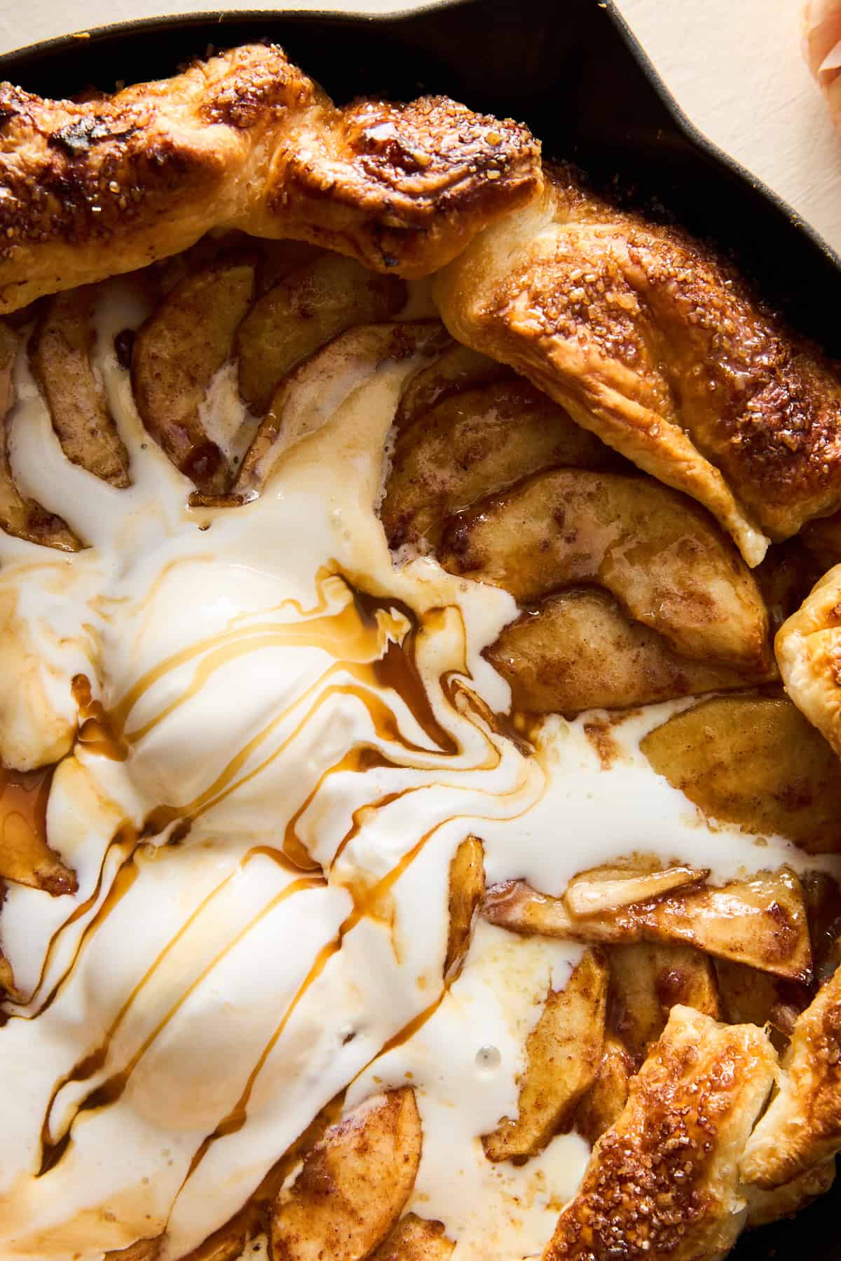 Close up image of Apple Galette with Puff Pastry topped with ice cream and caramel. 