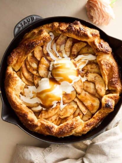 An apple galette topped with ice cream and caramel.