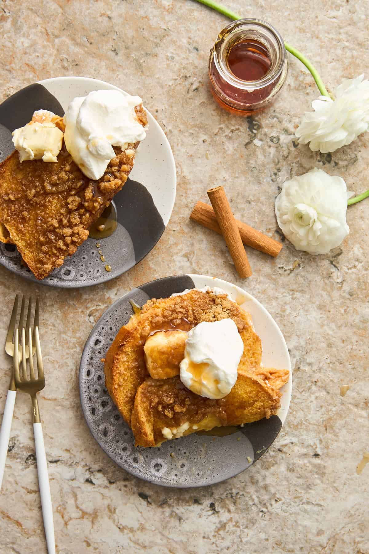 Plates of maple french toast topped with yogurt and butter. 