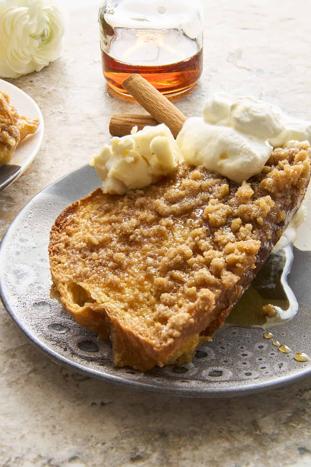 A plate of maple french toast topped with cream cheese.