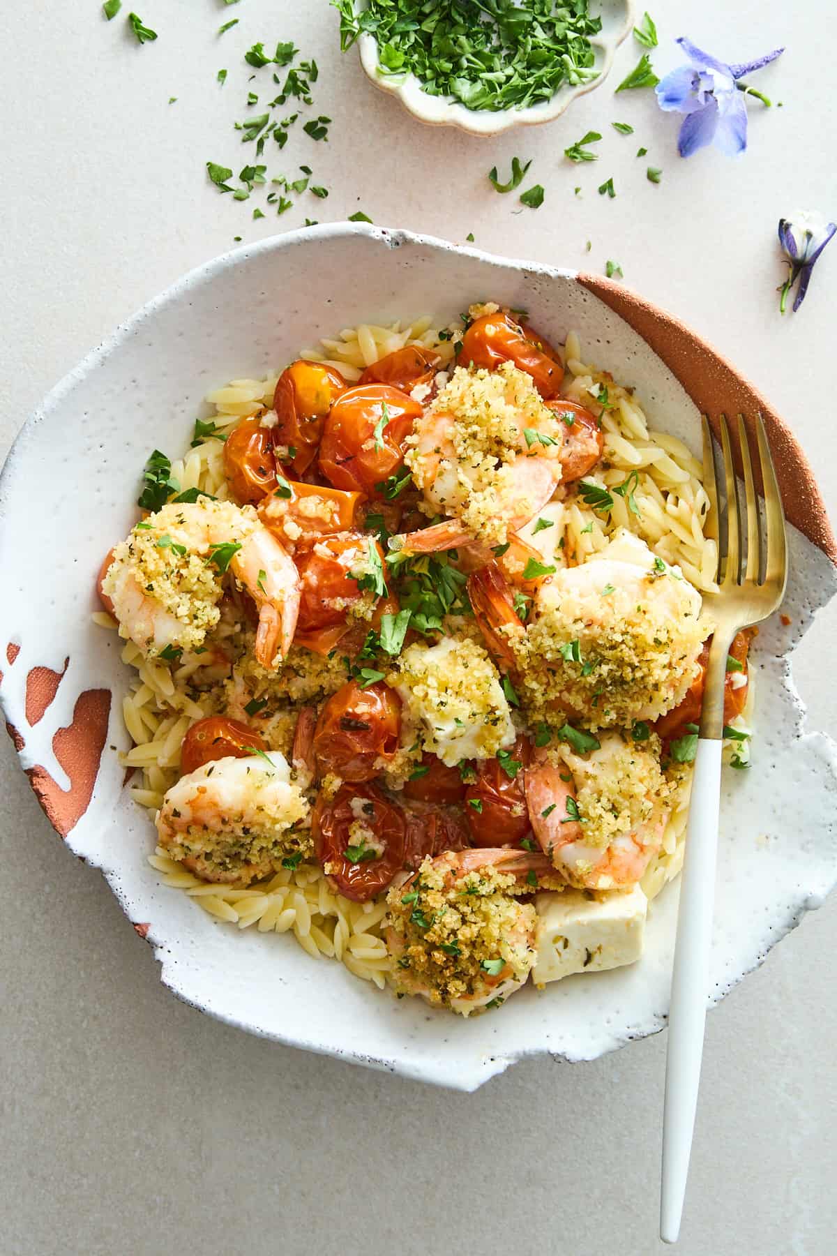 A bowl of Panko Shrimp and Feta Bake over orzo. 