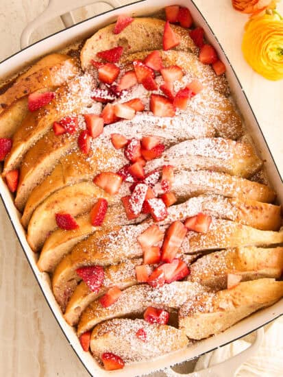 A baking dish full of whole pieces of strawberry french toast.