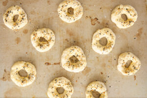 Unbaked cottage cheese bagels topped with egg wash and everything but the bagel seasoning.